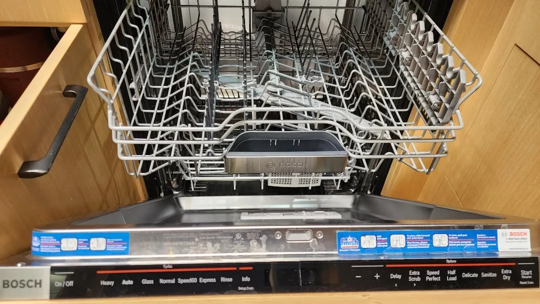 An open dishwasher with the upper rack pulled out