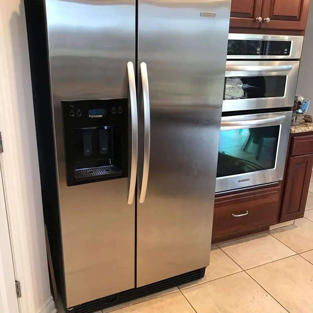 A stainless steel side-by-side fridge-freezer in a kitchen