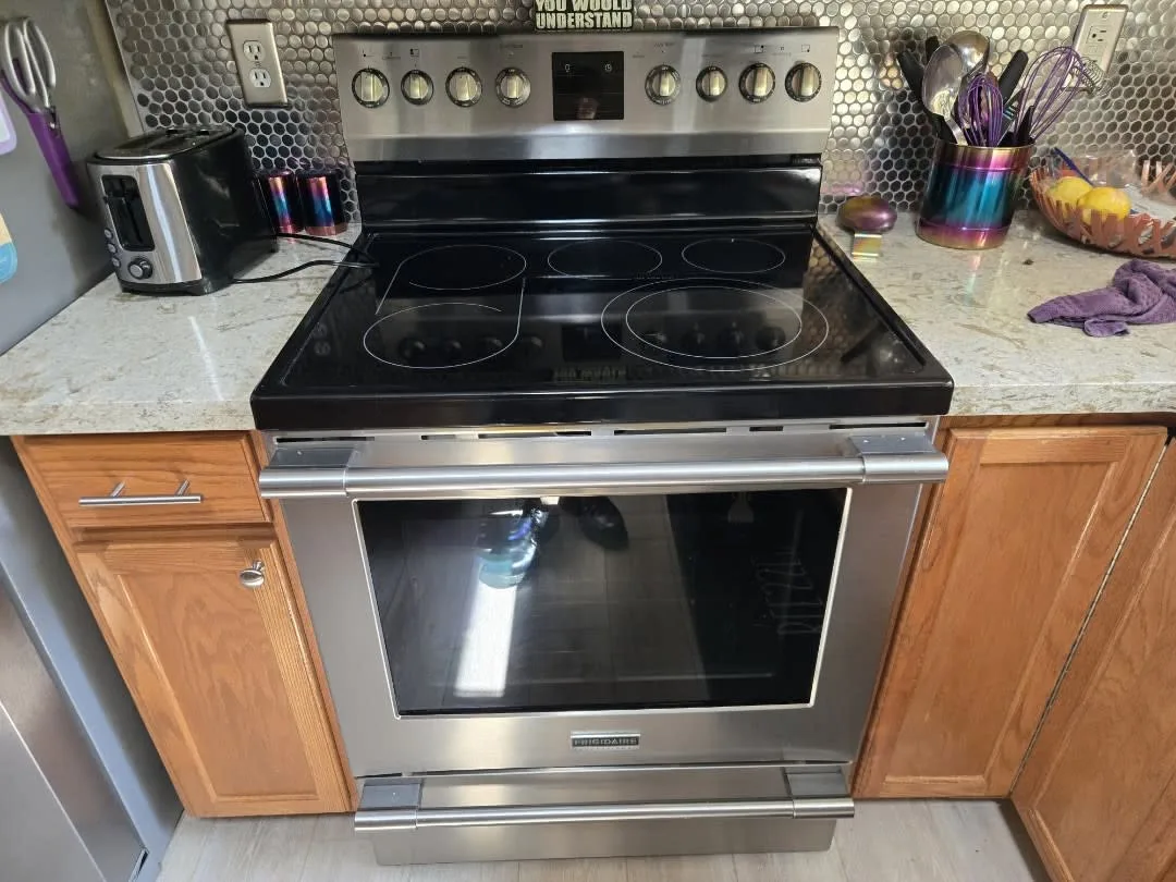 An electric stove with a glass top in a kitchen